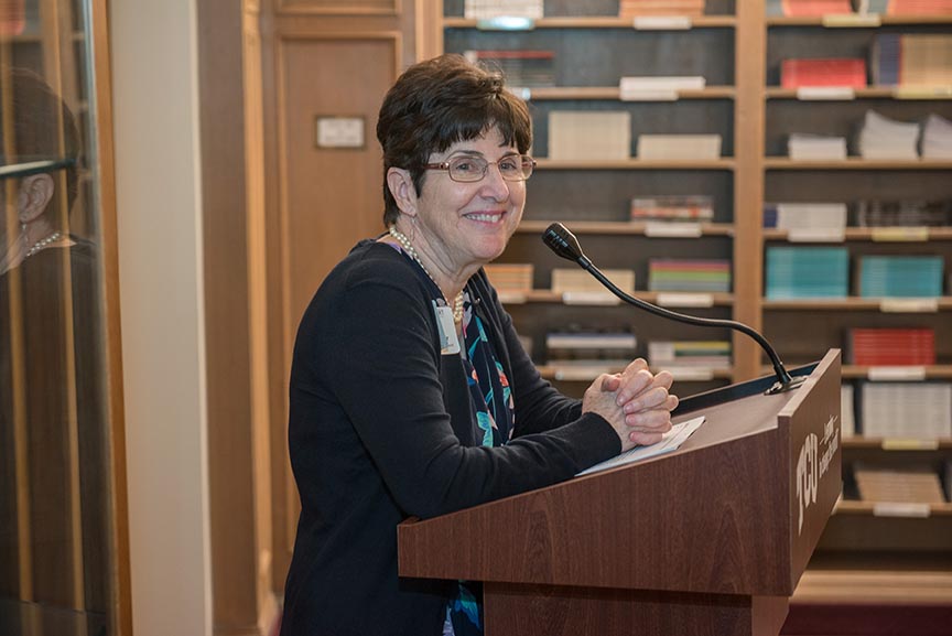 Dr. June Koelker, Dean of the TCU library, at the podium.
