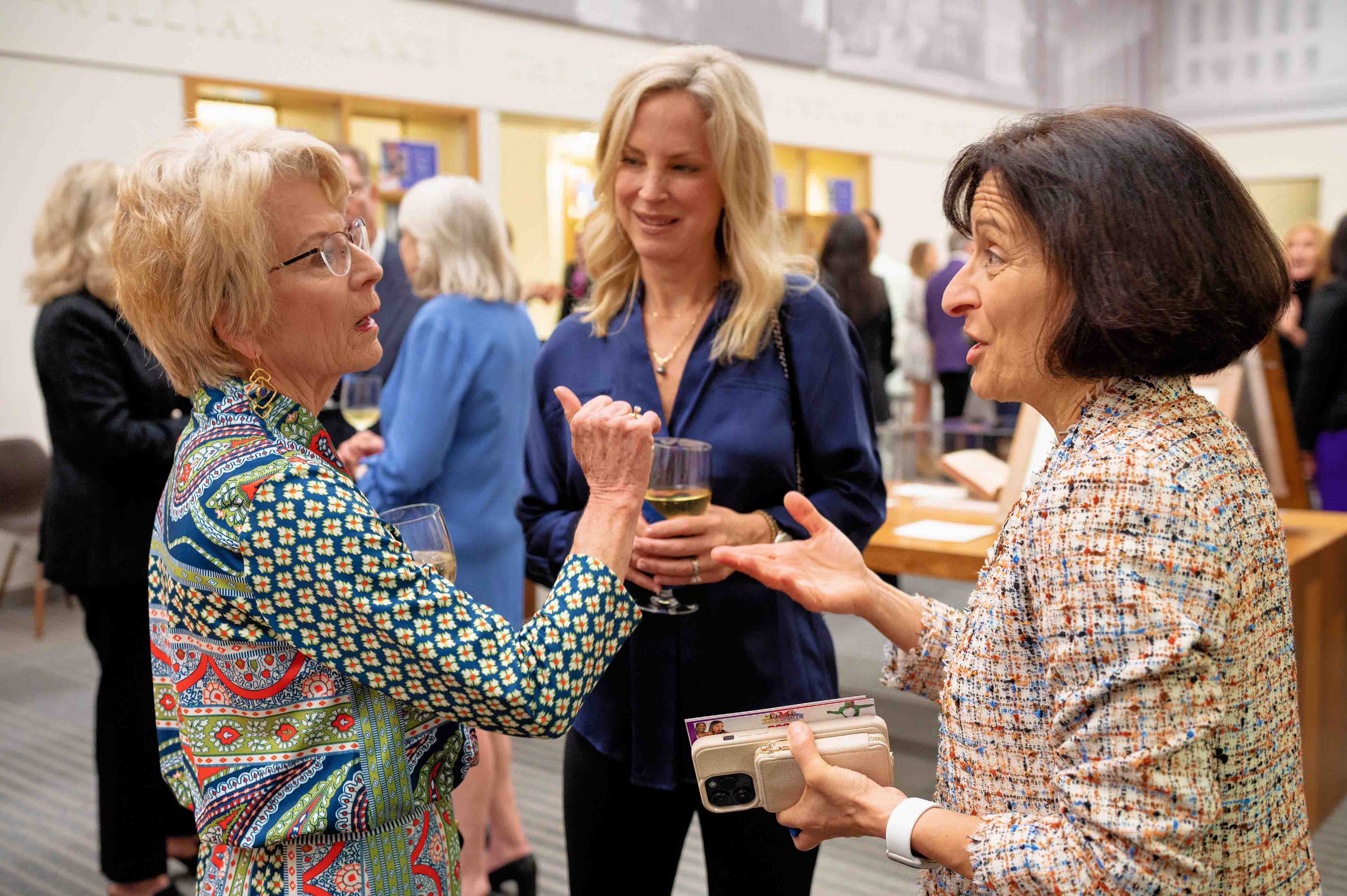 Fundraiser guests talking with Provost Teresa Dahlberg (right)
