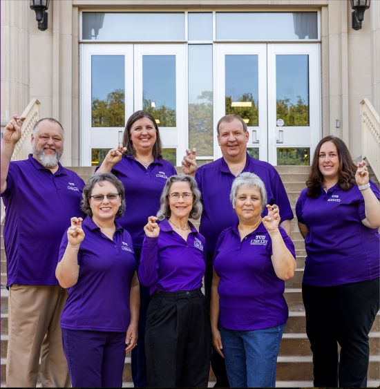 Reference librarians in front of TCU Mary Couts Burnett Library.